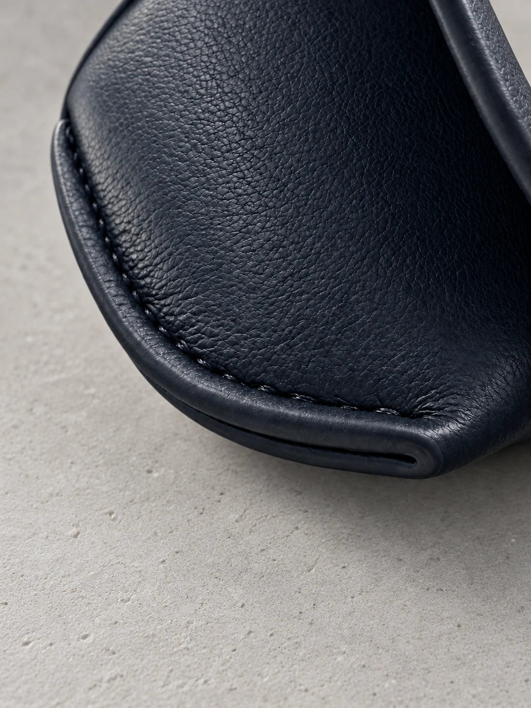 Close-up of the curved end seam of the case, stitched along its folded edge.
