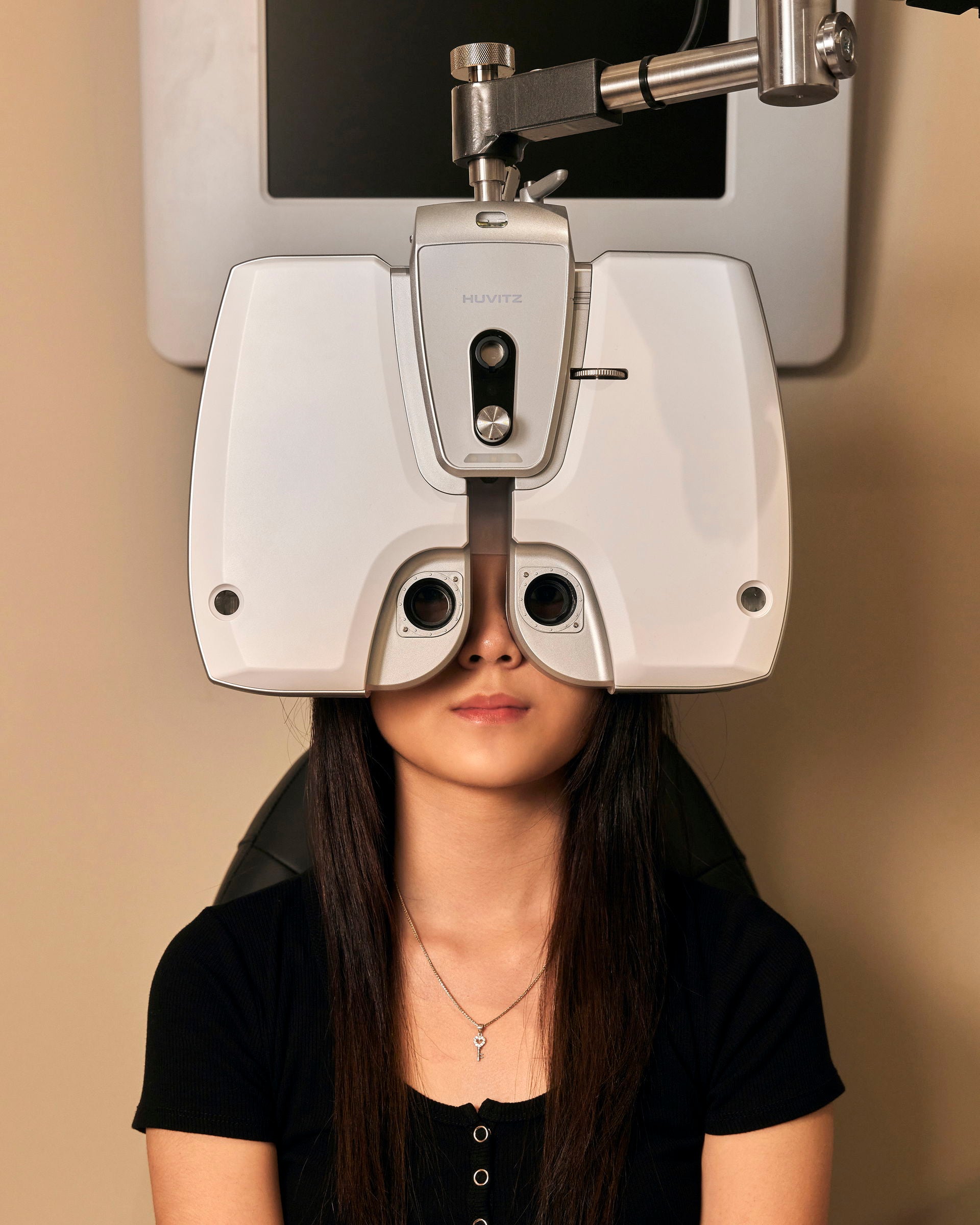 Customer completing an eye test with O+ optical equipment