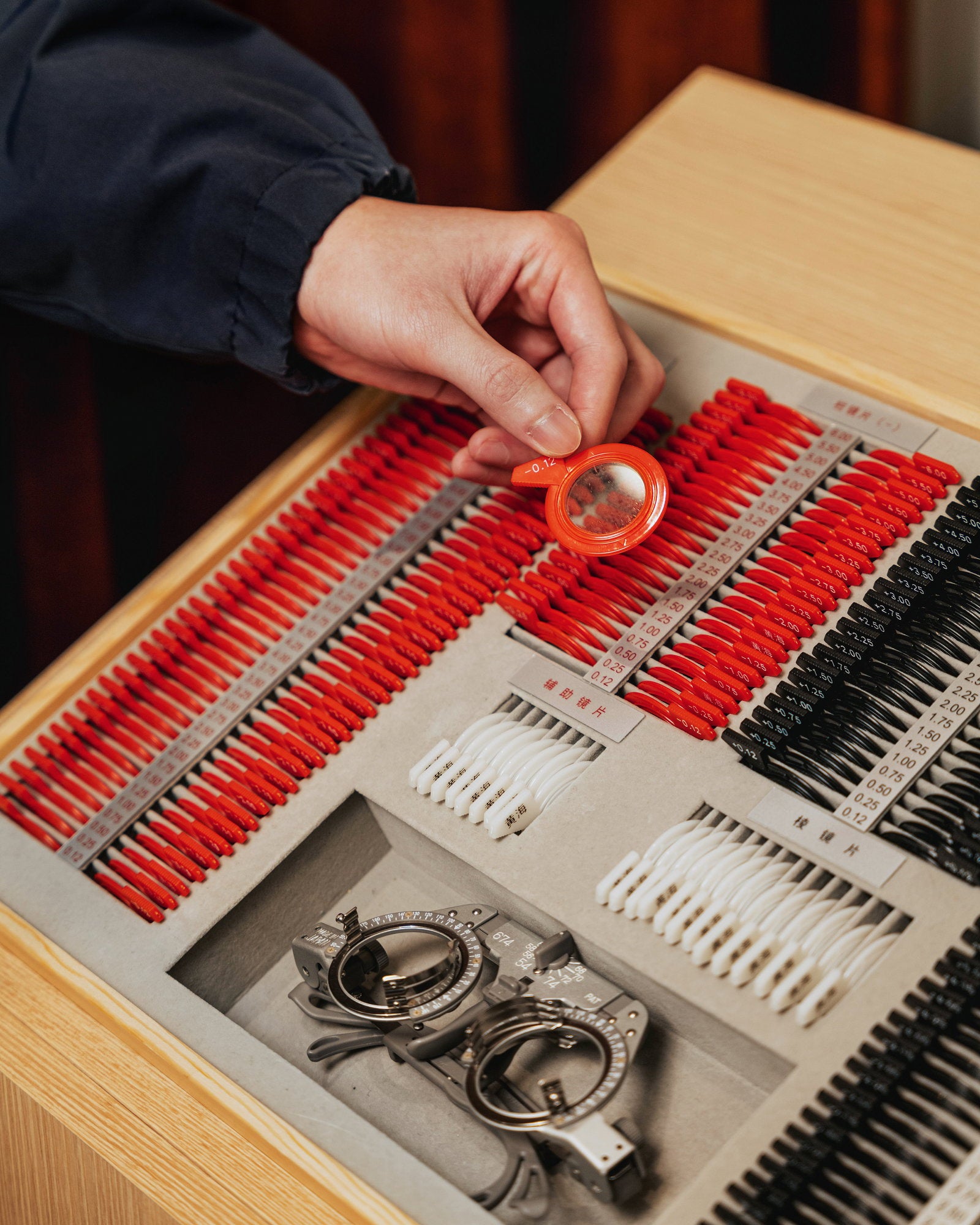 Optometrist preparing a trial frame for a customer