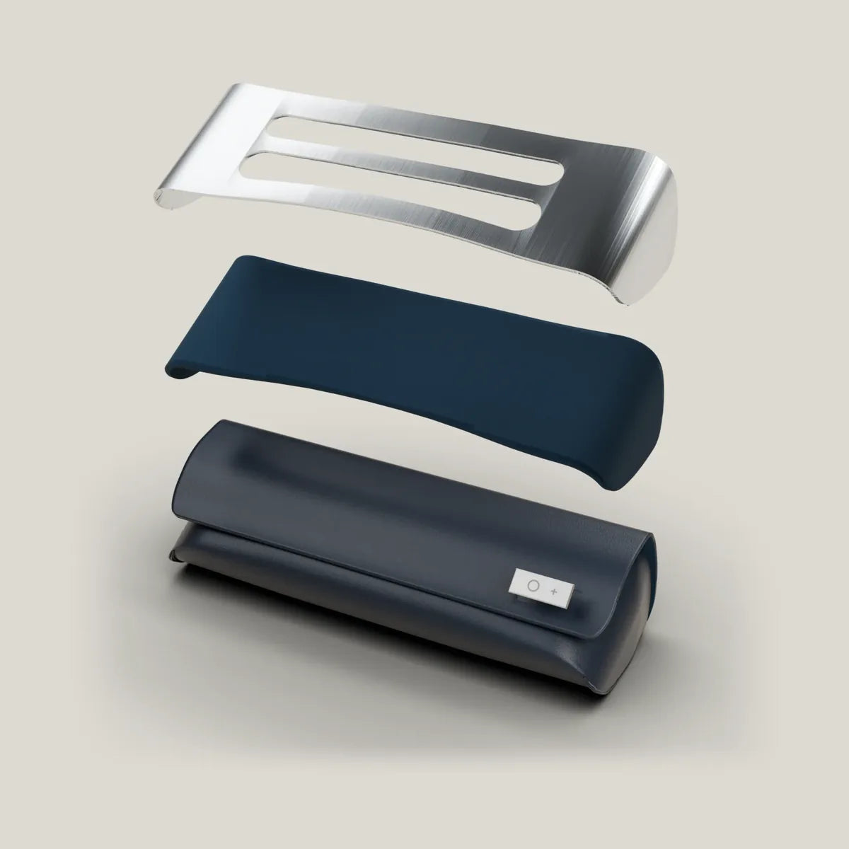 The Titanium Core Case separated into its layers: the titanium core on top, the navy flannelette lining, and the vegan-leather shell with its titanium signature.